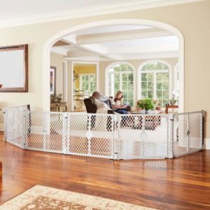 A baby gate on a living room floor